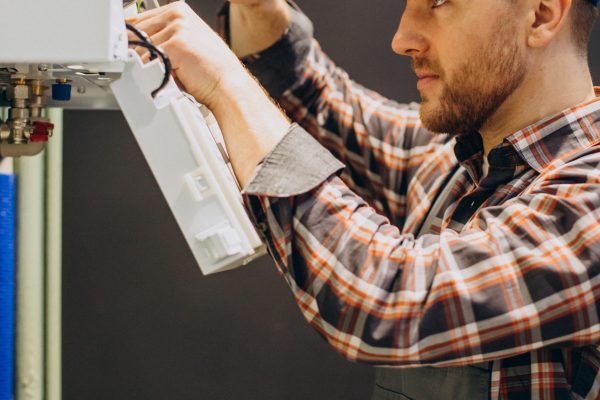 Service man adjusting house heating system